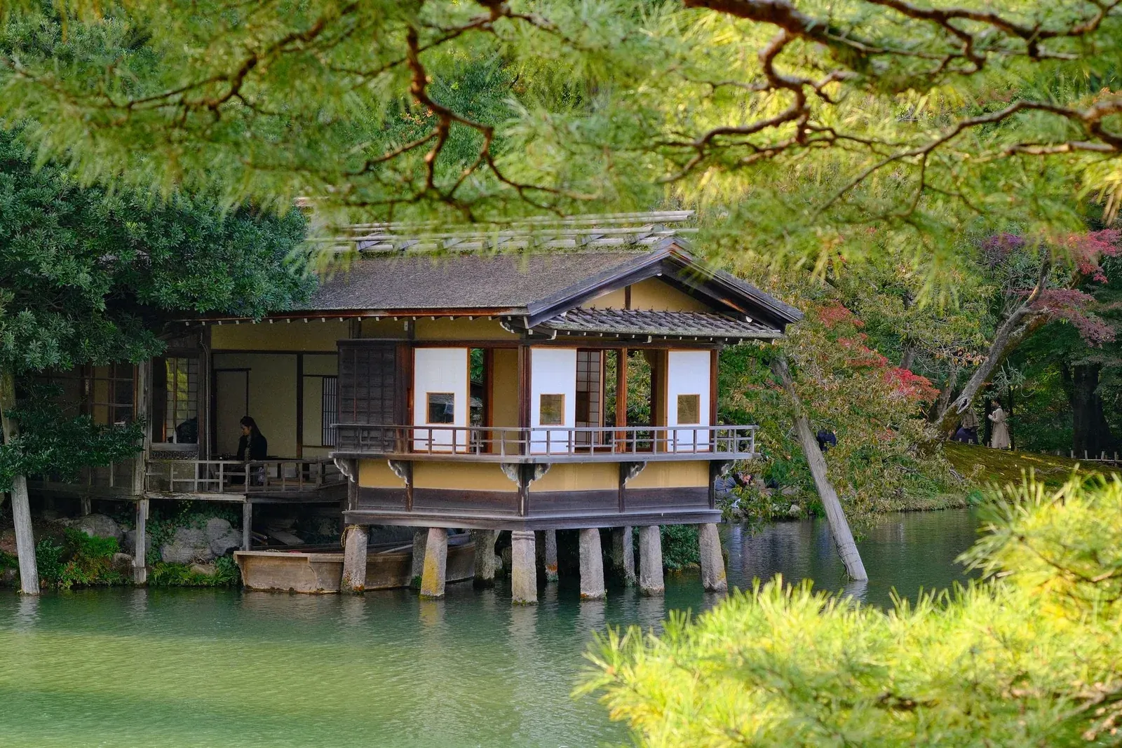 A wooden sukiya-style pavilion set over a garden pond in Kyoto