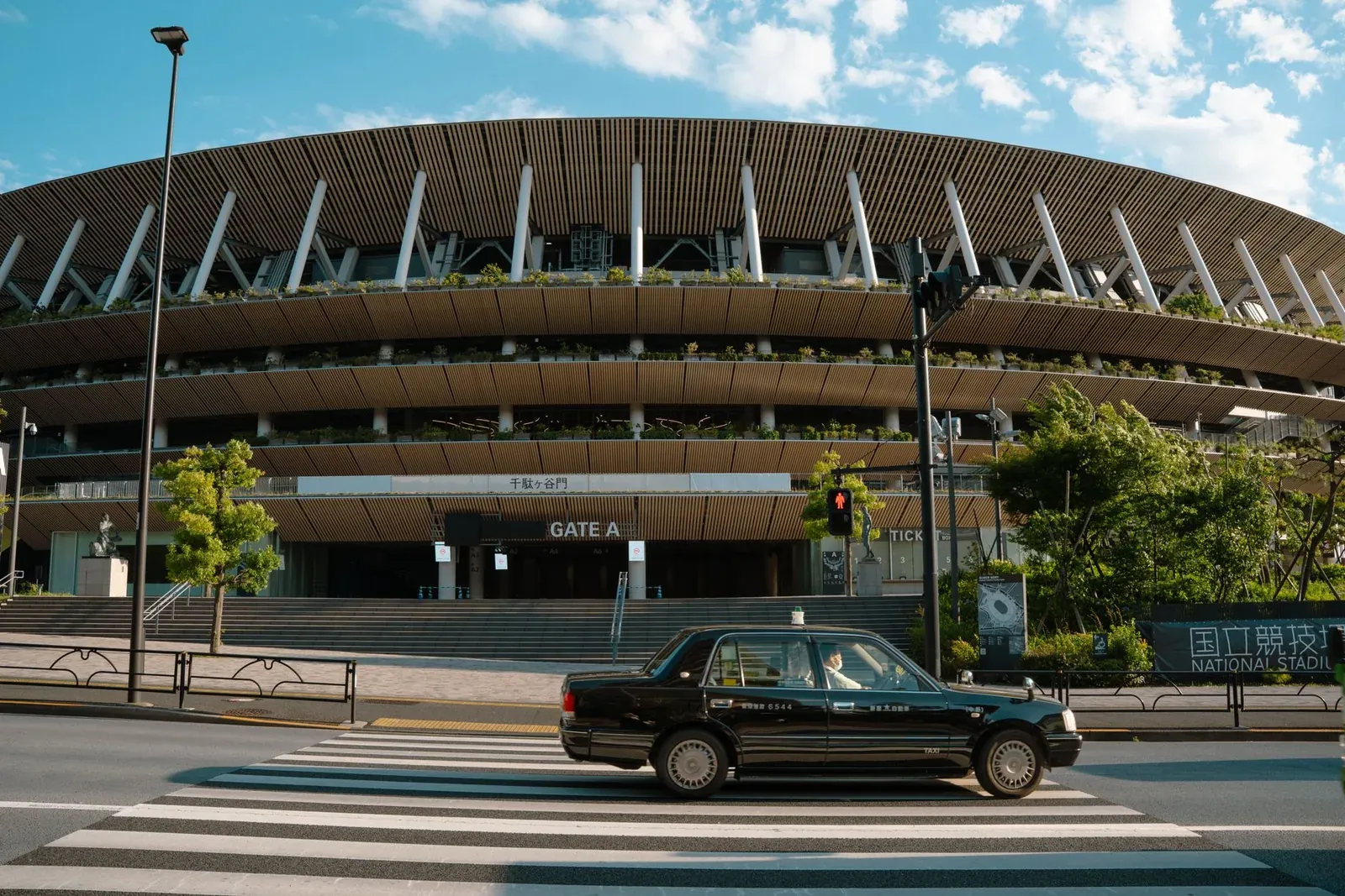 Timber-lined eaves of the Japan National Stadium in Tokyo seen from the street